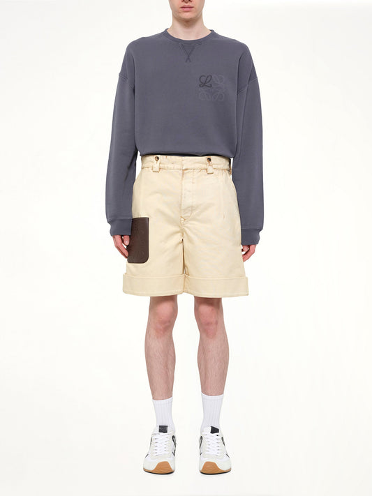 Image of a model wearing Shorts. Product name - Turn-Up Shorts in Beige colour by brand - LOEWE