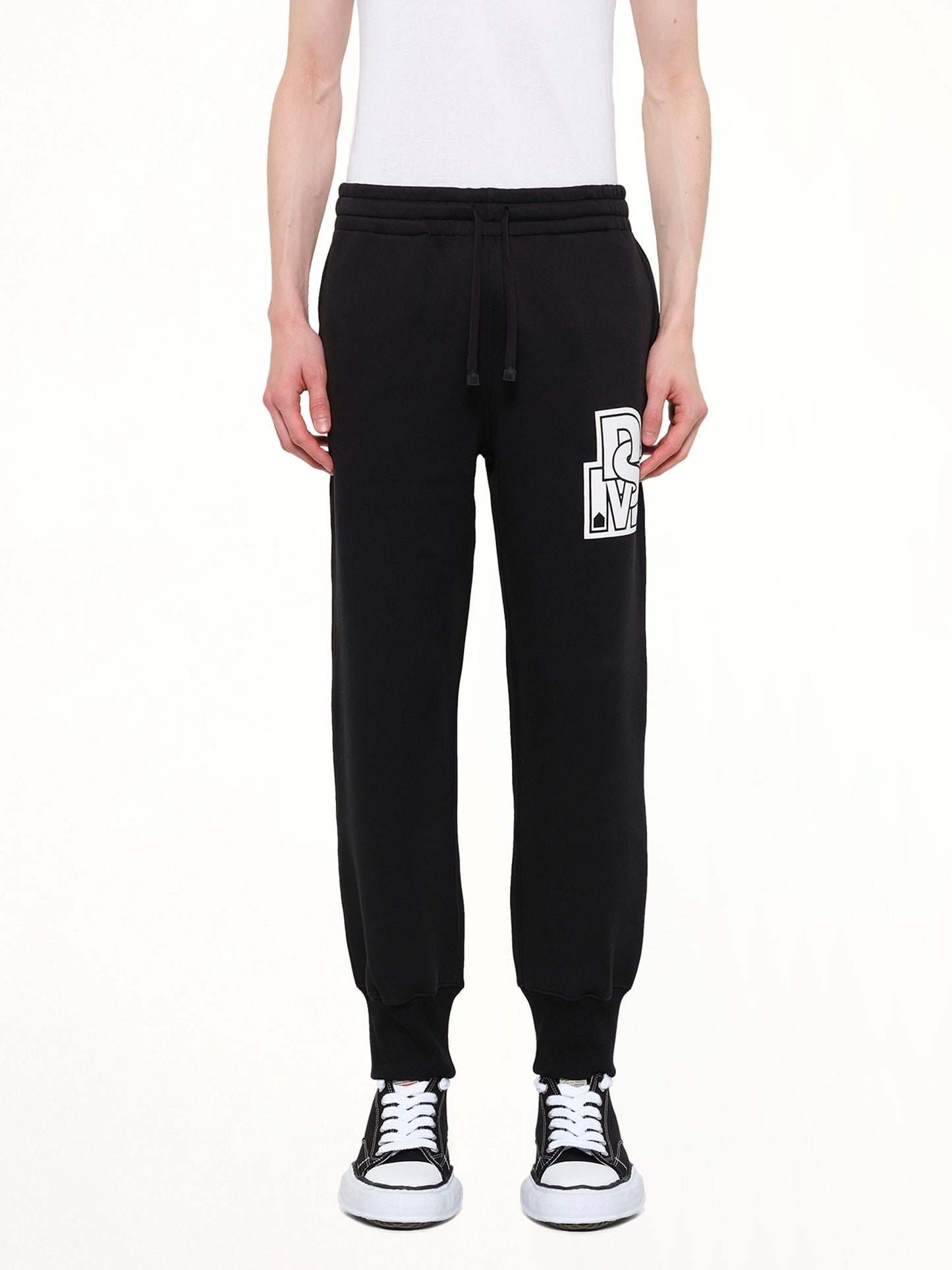 Image of a model wearing Pants. Product name - Double Knit Jogger Pants in Black colour by brand - DSM KEI NINOMIYA