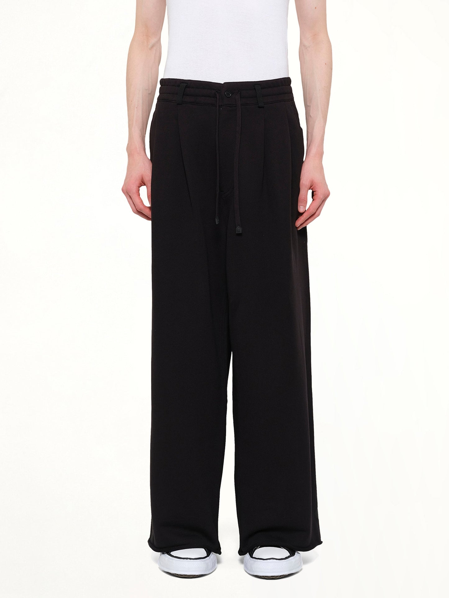 Image of a model wearing Pants. Product name - Pile Knit Pleated Pants in Black colour by brand - DSM KEI NINOMIYA