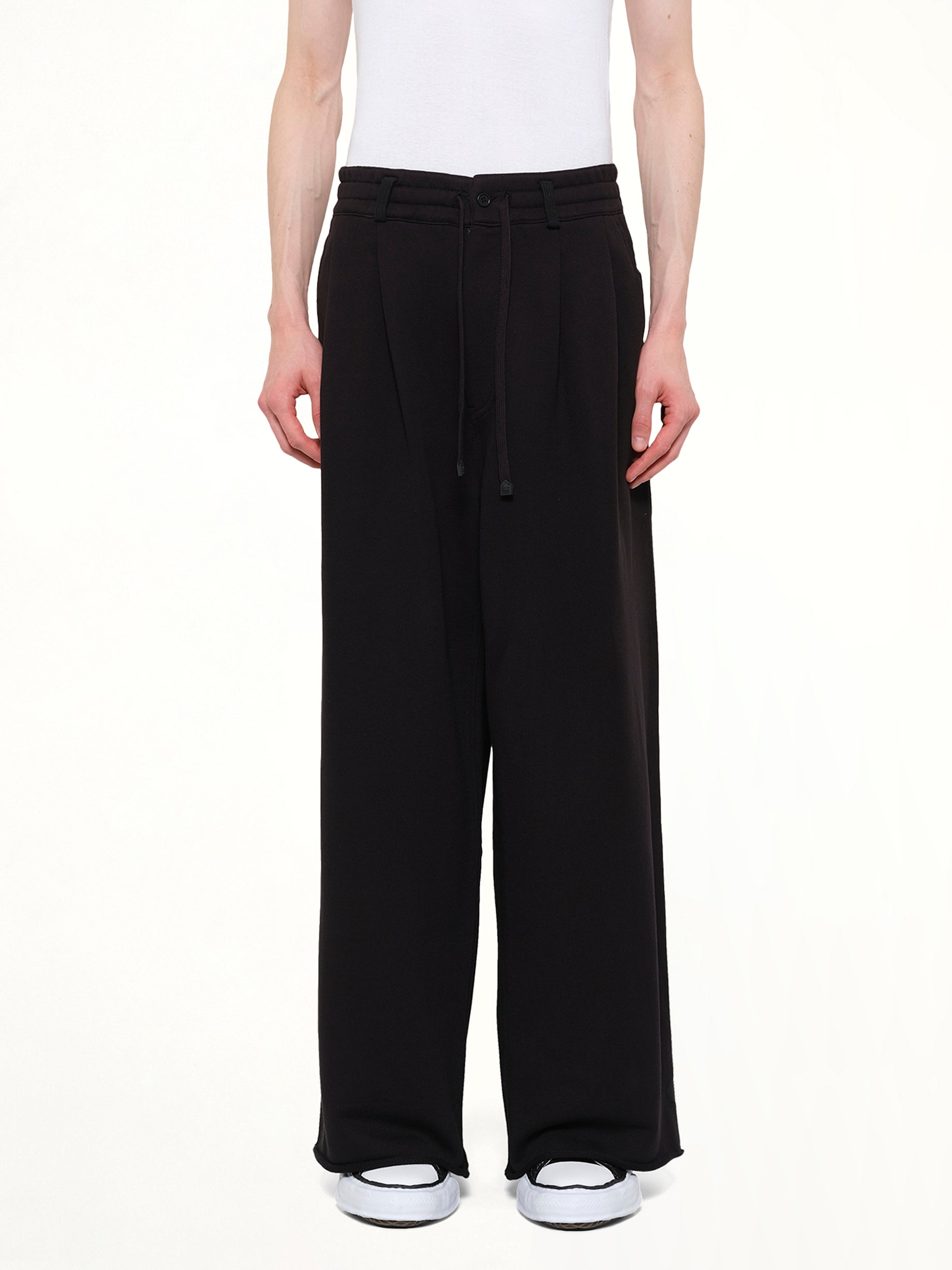 Image of a model wearing Pants. Product name - Pile Knit Pleated Pants in Black colour by brand - DSM KEI NINOMIYA