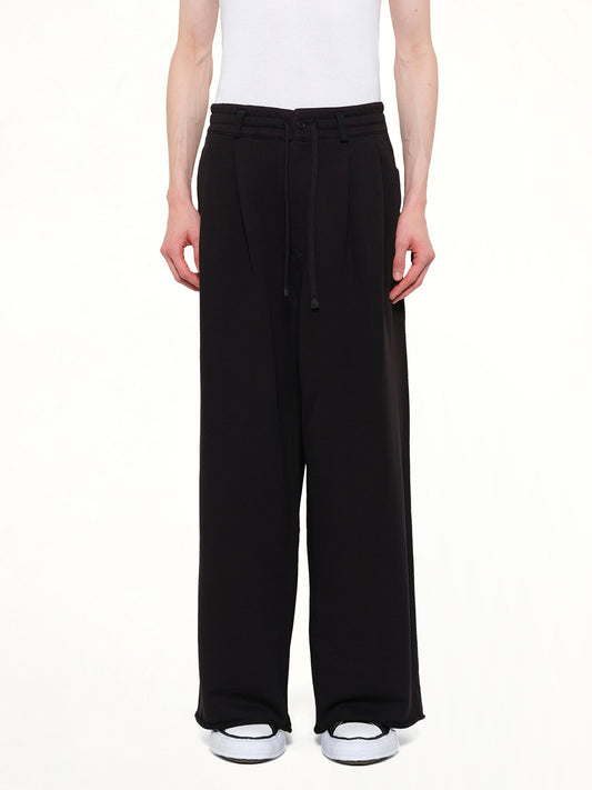 Image of a model wearing Pants. Product name - Pile Knit Pleated Pants in Black colour by brand - DSM KEI NINOMIYA