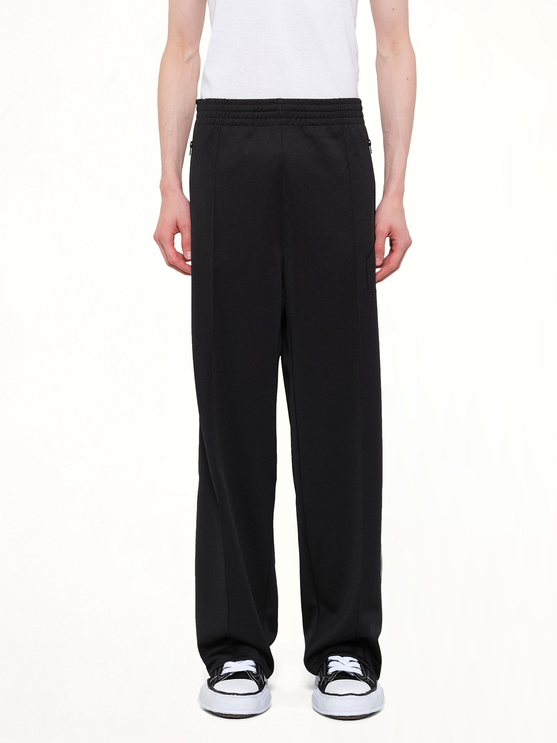 Image of a model wearing Pants. Product name - Tracksuit Pants in Black colour by brand - DSM KEI NINOMIYA