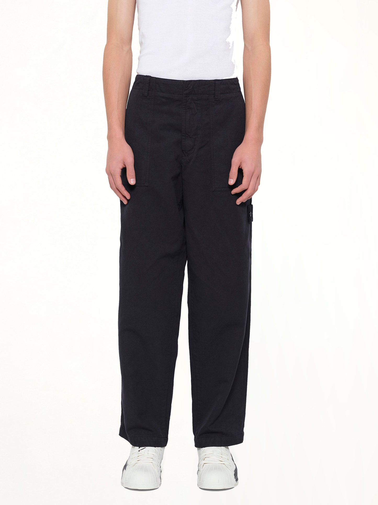 Image of a model wearing Pants. Product name - 3100016 Trousers in Navy colour by brand - STONE ISLAND