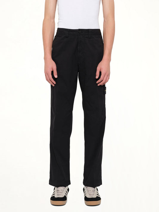 Image of a model wearing Pants. Product name - 3100021 Trousers in Black colour by brand - STONE ISLAND