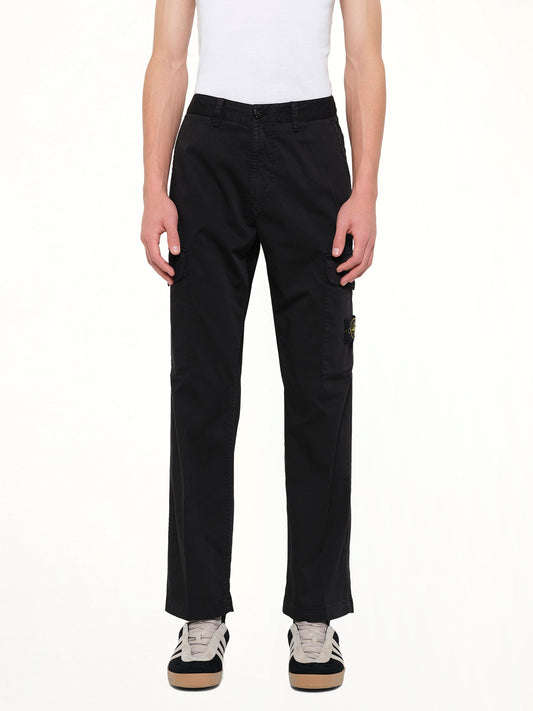 Image of a model wearing Pants. Product name - 3100023 Trousers in Black colour by brand - STONE ISLAND