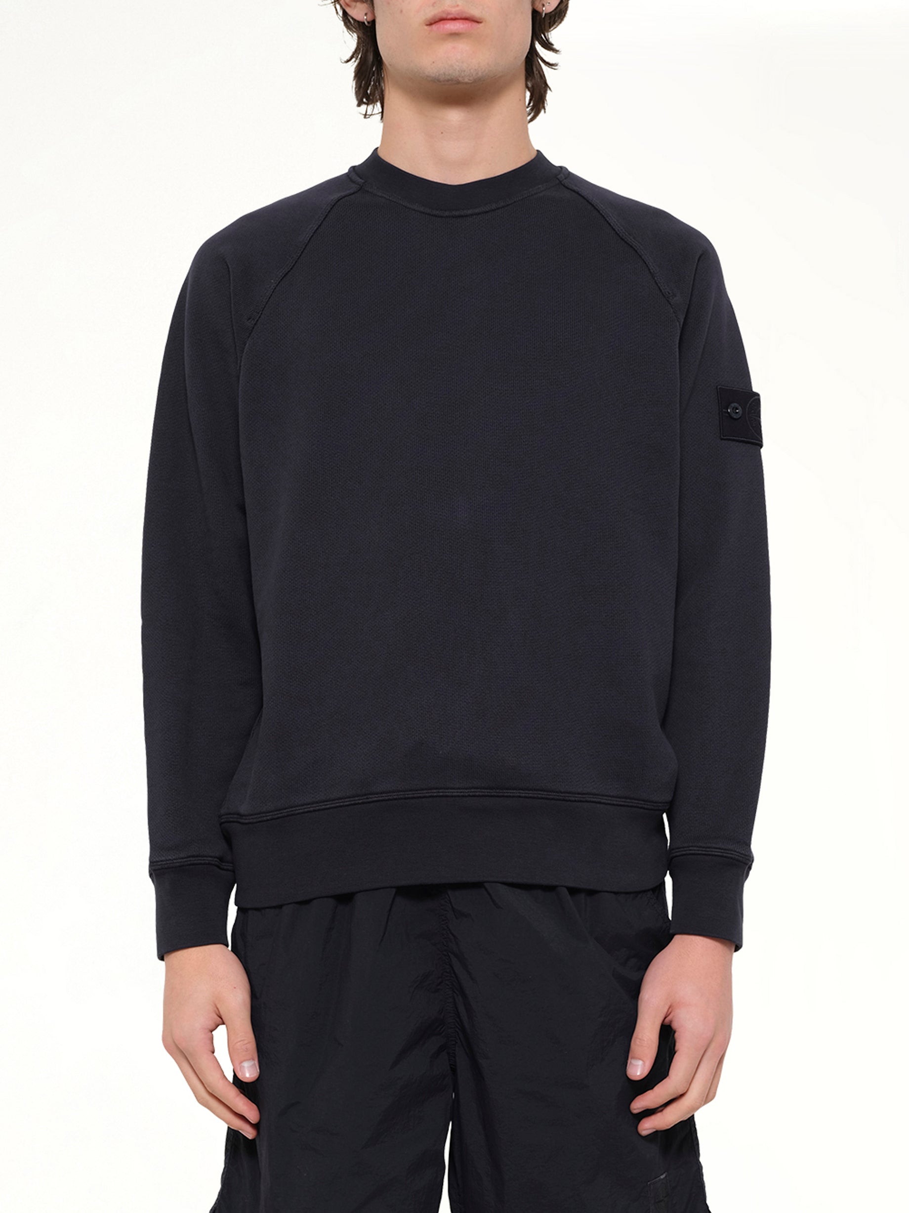Image of a model wearing Outerwear. Product name - 6100028 Sweatshirt in Navy colour by brand - STONE ISLAND