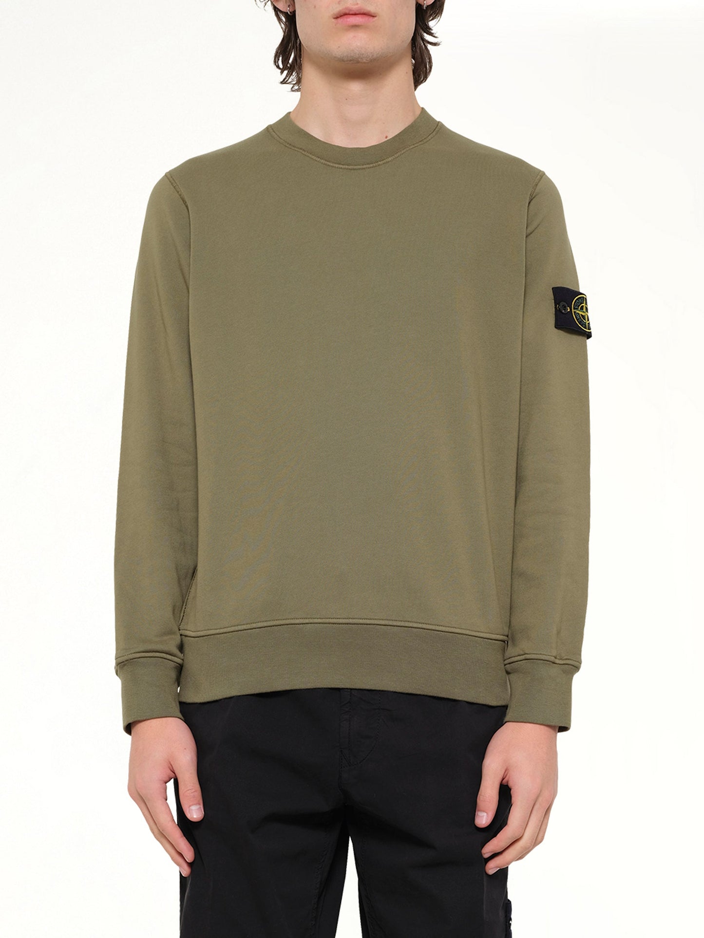 Image of a model wearing Outerwear. Product name - 6100060 Sweatshirt in Green colour by brand - STONE ISLAND