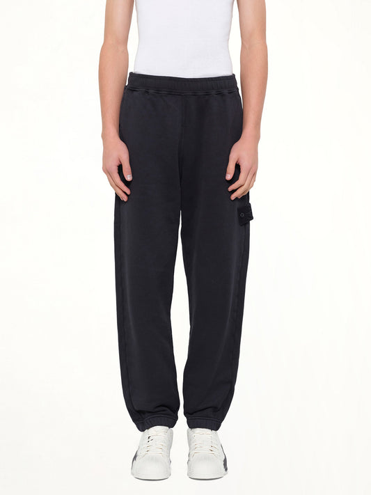 Image of a model wearing Pants. Product name - 6200008 Sweat Pants in Navy colour by brand - STONE ISLAND
