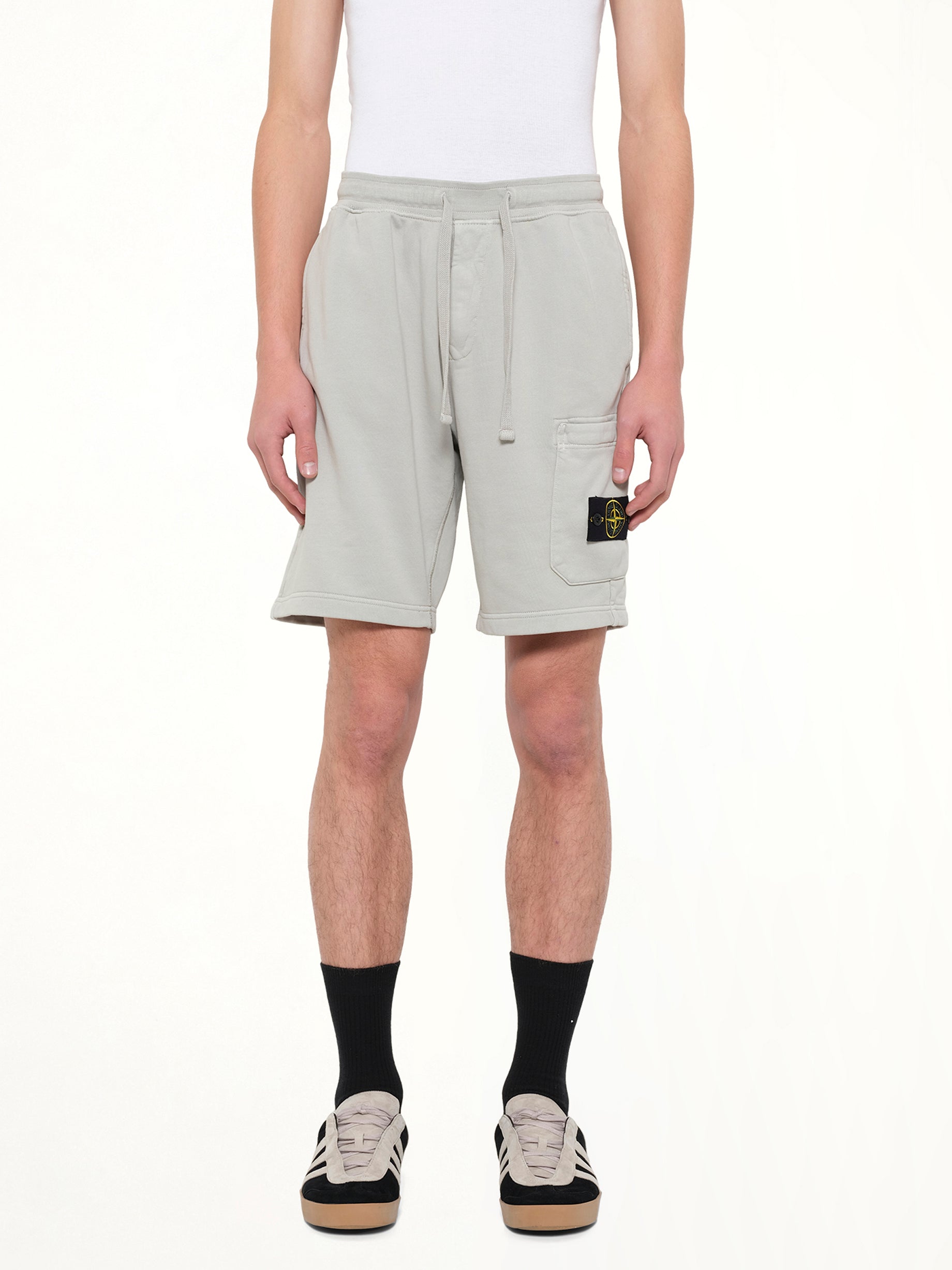Image of a model wearing Shorts. Product name - 6200011 Shorts in Grey colour by brand - STONE ISLAND