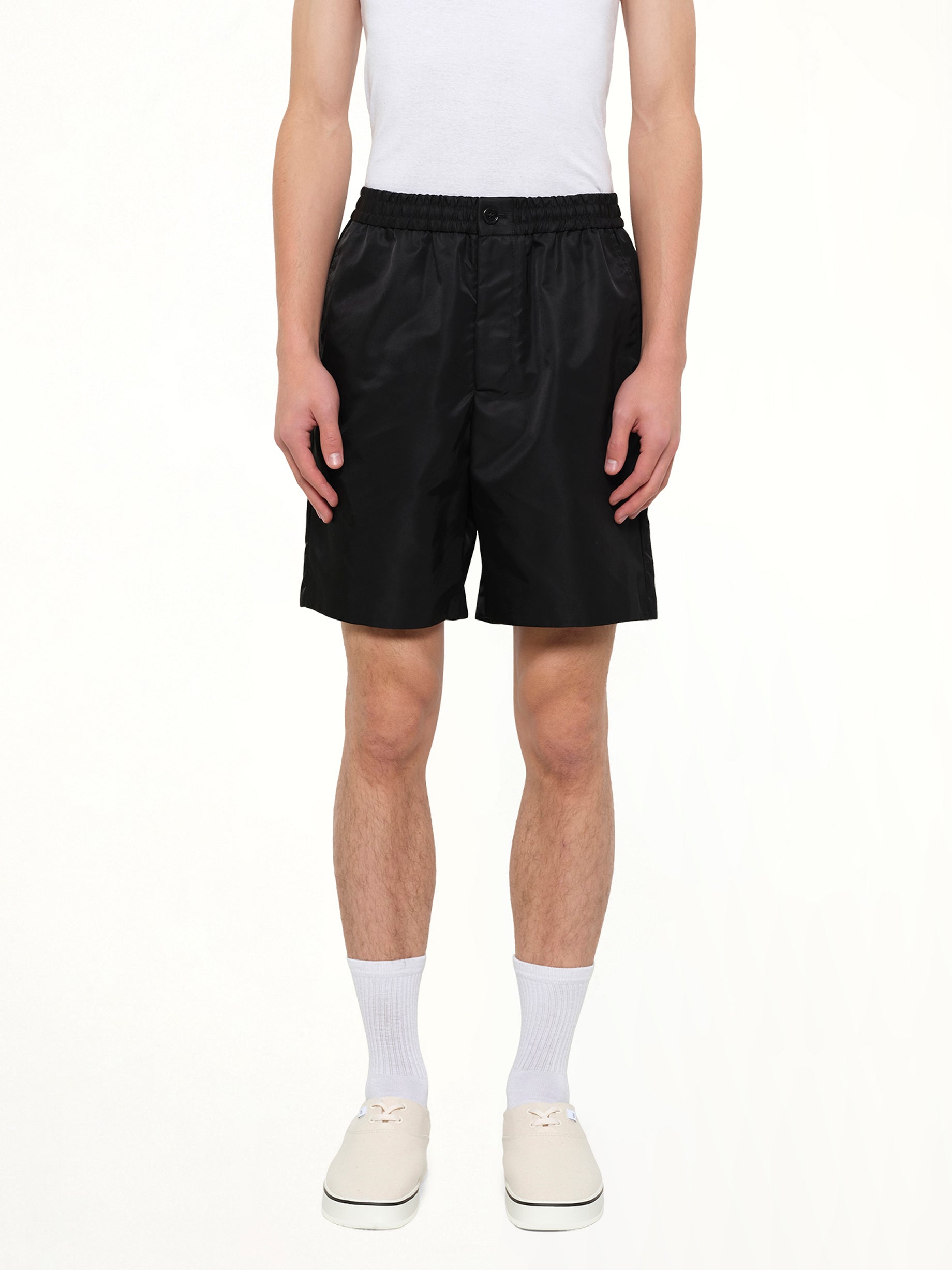 Image of a model wearing Shorts. Product name - Ami De Coeur Stud Shorts in Black colour by brand - AMI PARIS