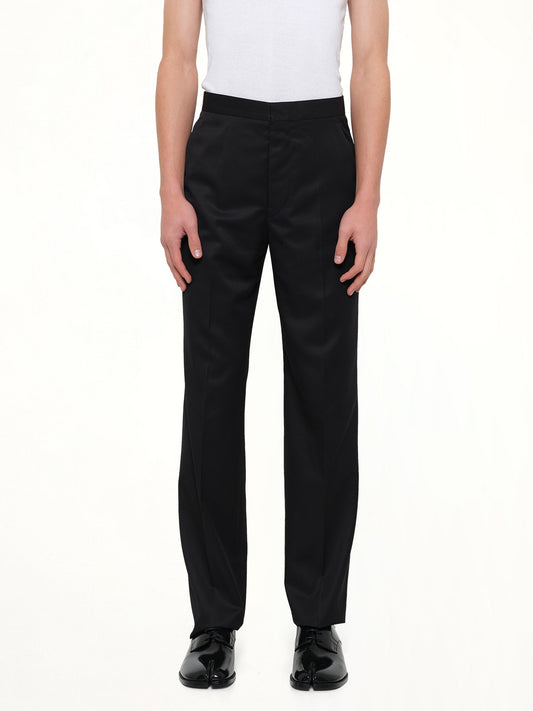 Image of a model wearing Pants. Product name - Compact Light Wool Suit Pants in Black colour by brand - MAISON MARGIELA