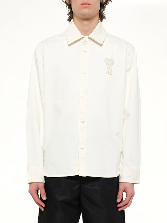 Image of a model wearing Tops. Product name - Knitted ADC Overshirt in White colour by brand - AMI PARIS