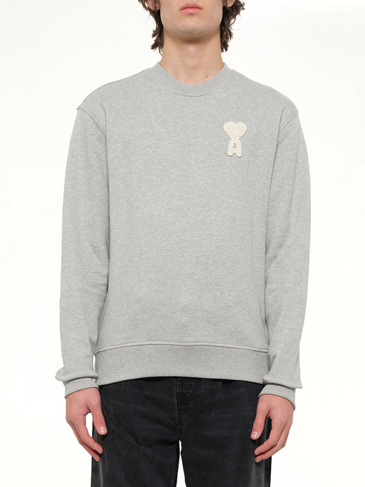 Image of a model wearing Outerwear. Product name - Knitted ADC Sweatshirt in Grey colour by brand - AMI PARIS