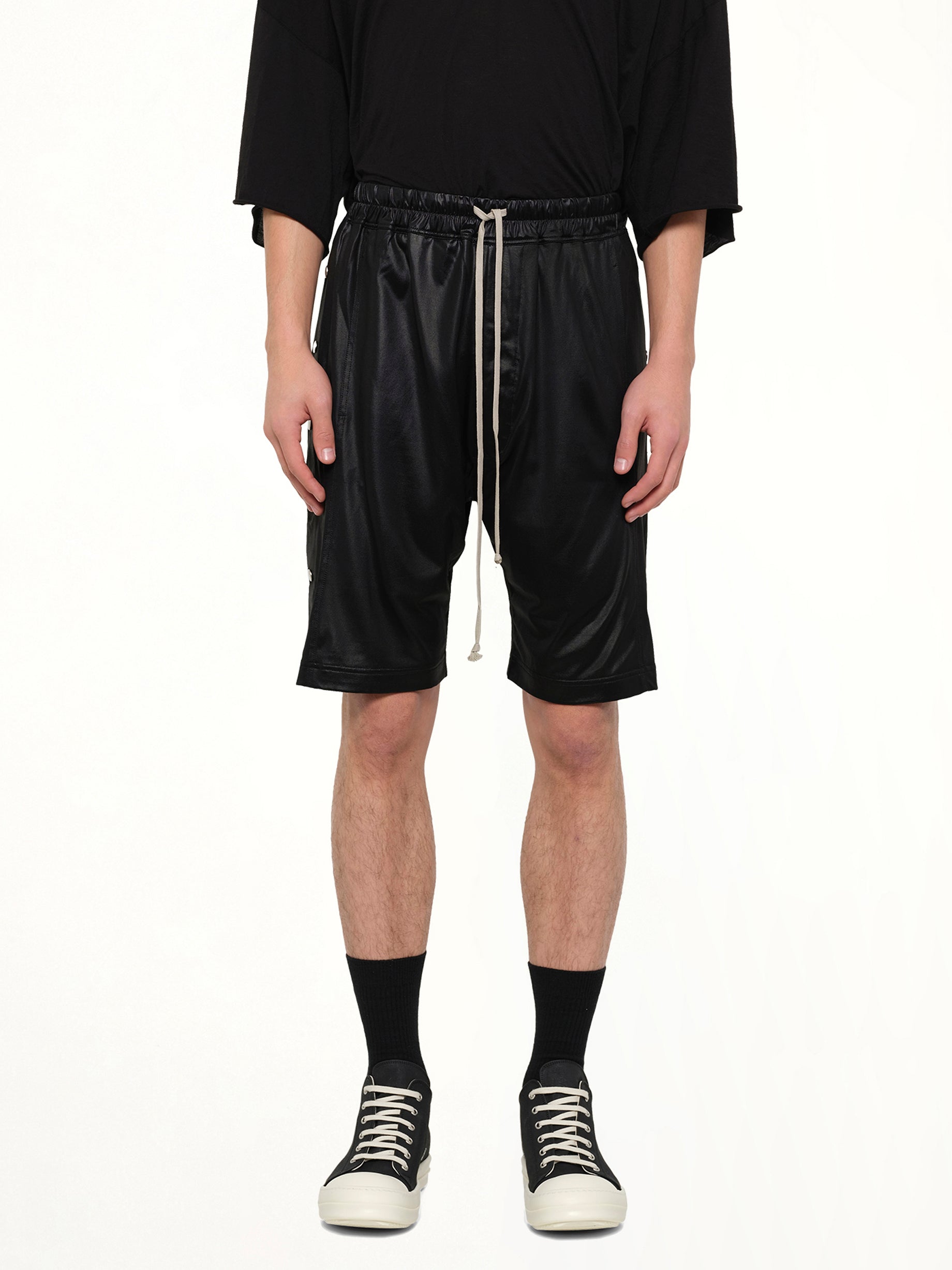 Image of a model wearing Shorts. Product name - Light Wide Pusher Shorts in Black colour by brand - RICK OWENS DRKSHDW