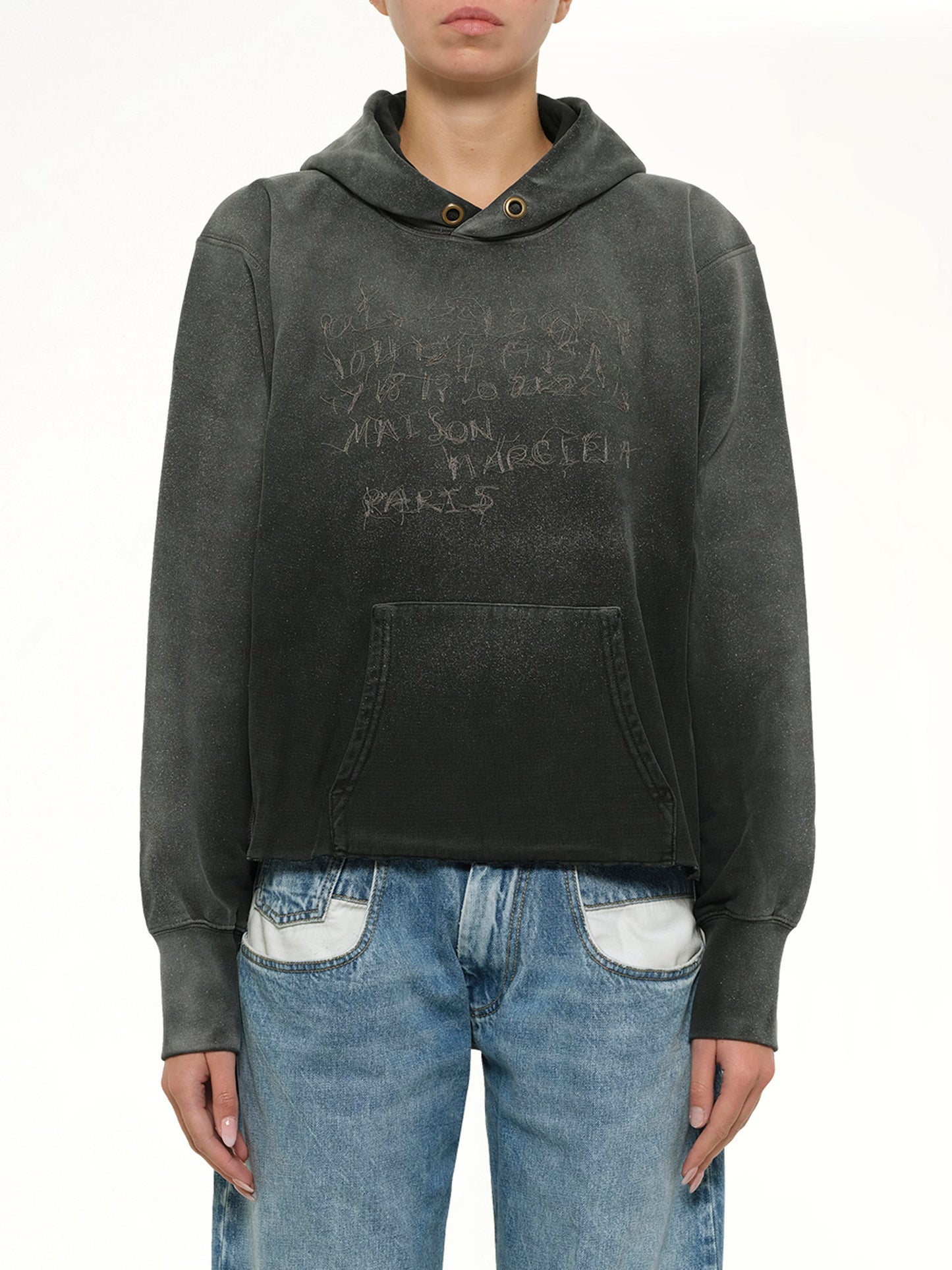 Image of a model wearing Outerwear. Product name - Number Hoodie in Black colour by brand - MAISON MARGIELA