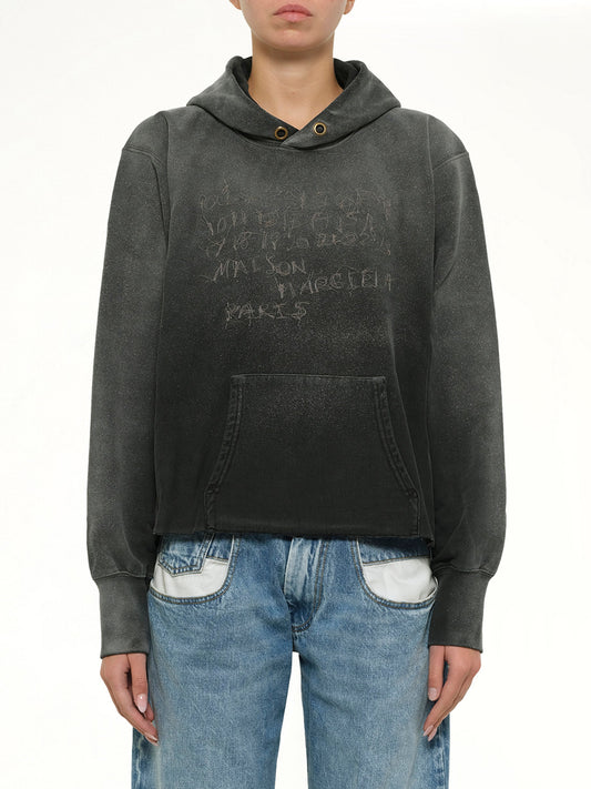Image of a model wearing Outerwear. Product name - Number Hoodie in Black colour by brand - MAISON MARGIELA