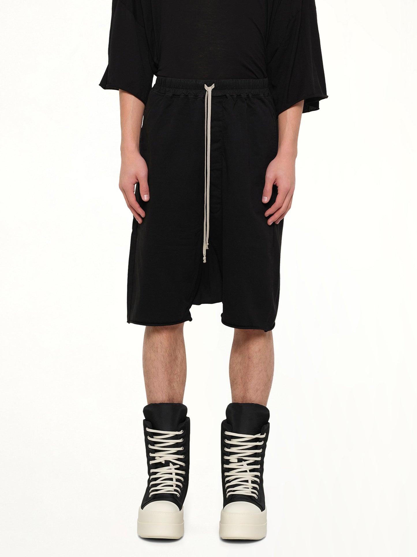Image of a model wearing Shorts. Product name - Drawstring Pods in Black colour by brand - RICK OWENS DRKSHDW