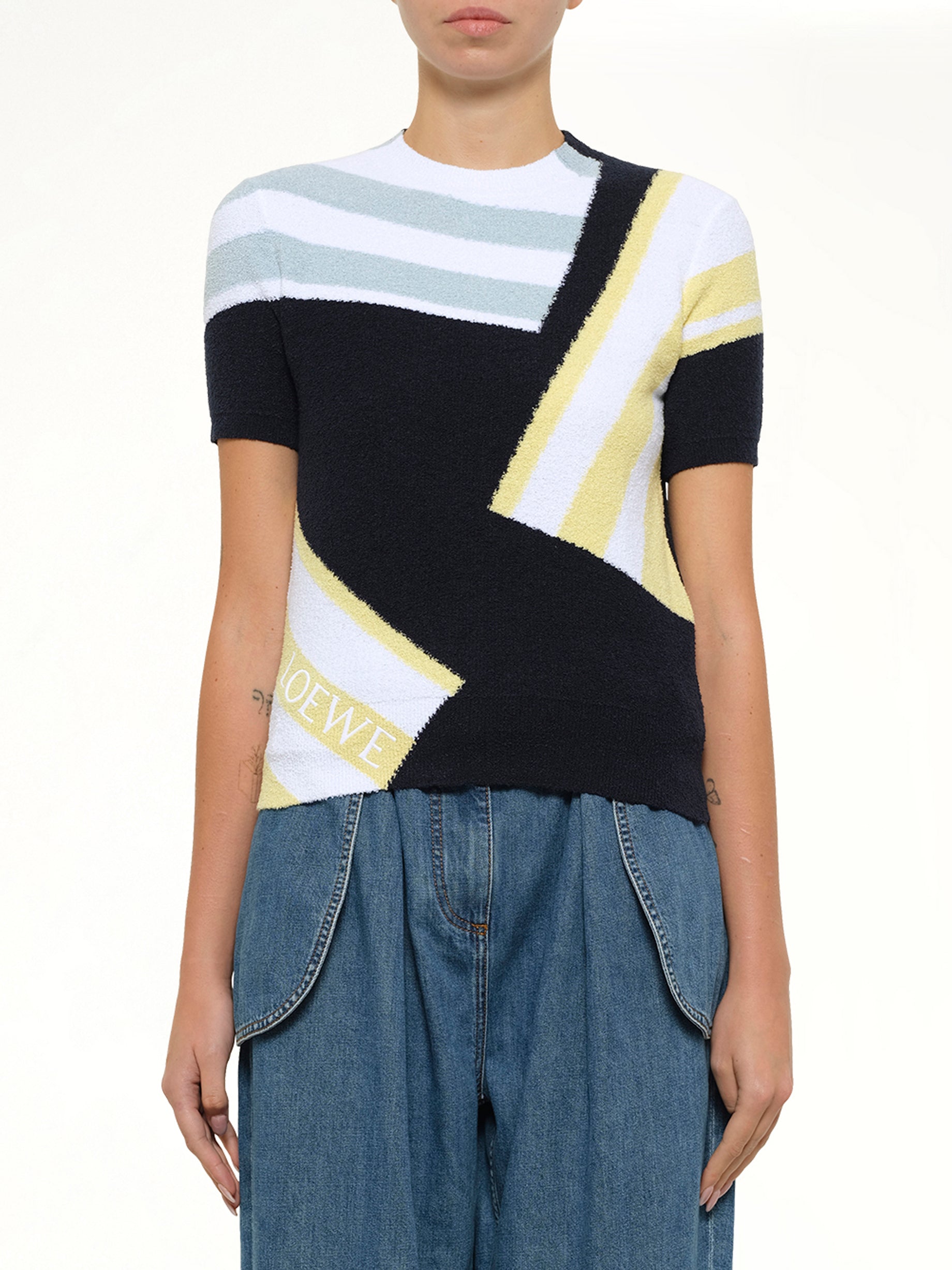 Image of a model wearing Outerwear. Product name - Short Sleeve Sweater in Blue colour by brand - LOEWE