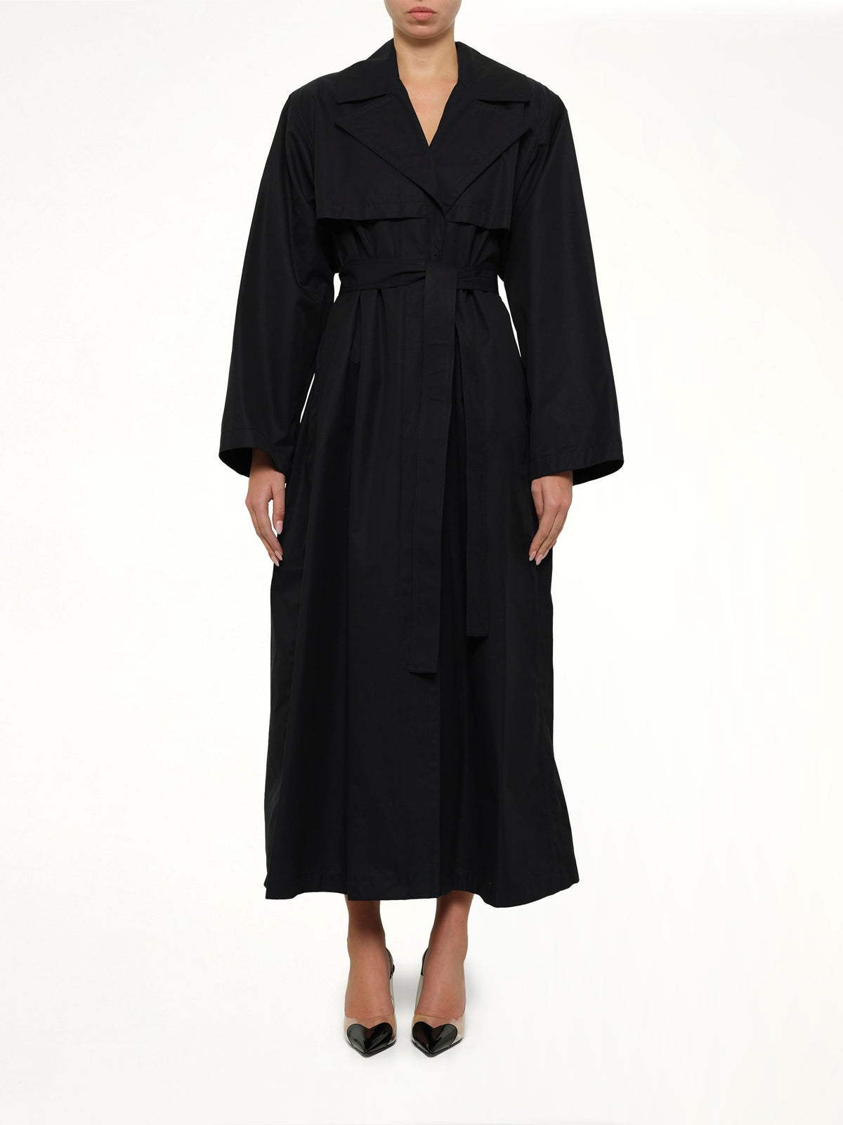 Image of a model wearing Outerwear. Product name - Trench Coat in Navy colour by brand - ALAIA