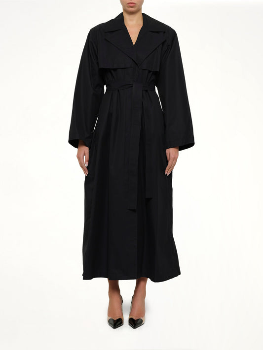 Image of a model wearing Outerwear. Product name - Trench Coat in Navy colour by brand - ALAIA