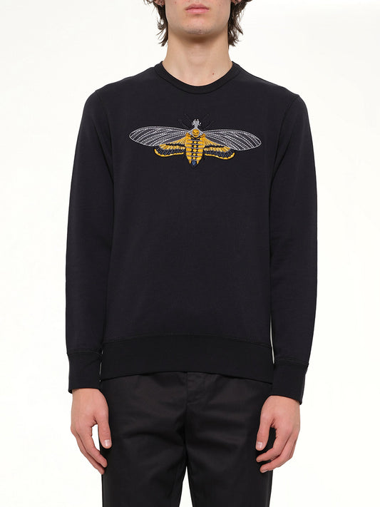 Image of a model wearing Outerwear. Product name - Moth Embroidered Sweatshirt in 901 colour by brand - ALEXANDER MCQUEEN