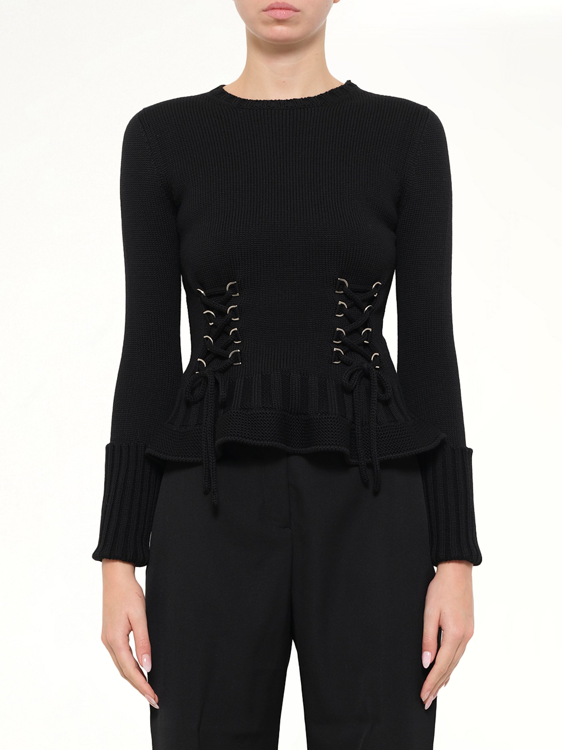 Image of a model wearing Outerwear. Product name - Lace Up Pullover in Black colour by brand - ALEXANDER MCQUEEN