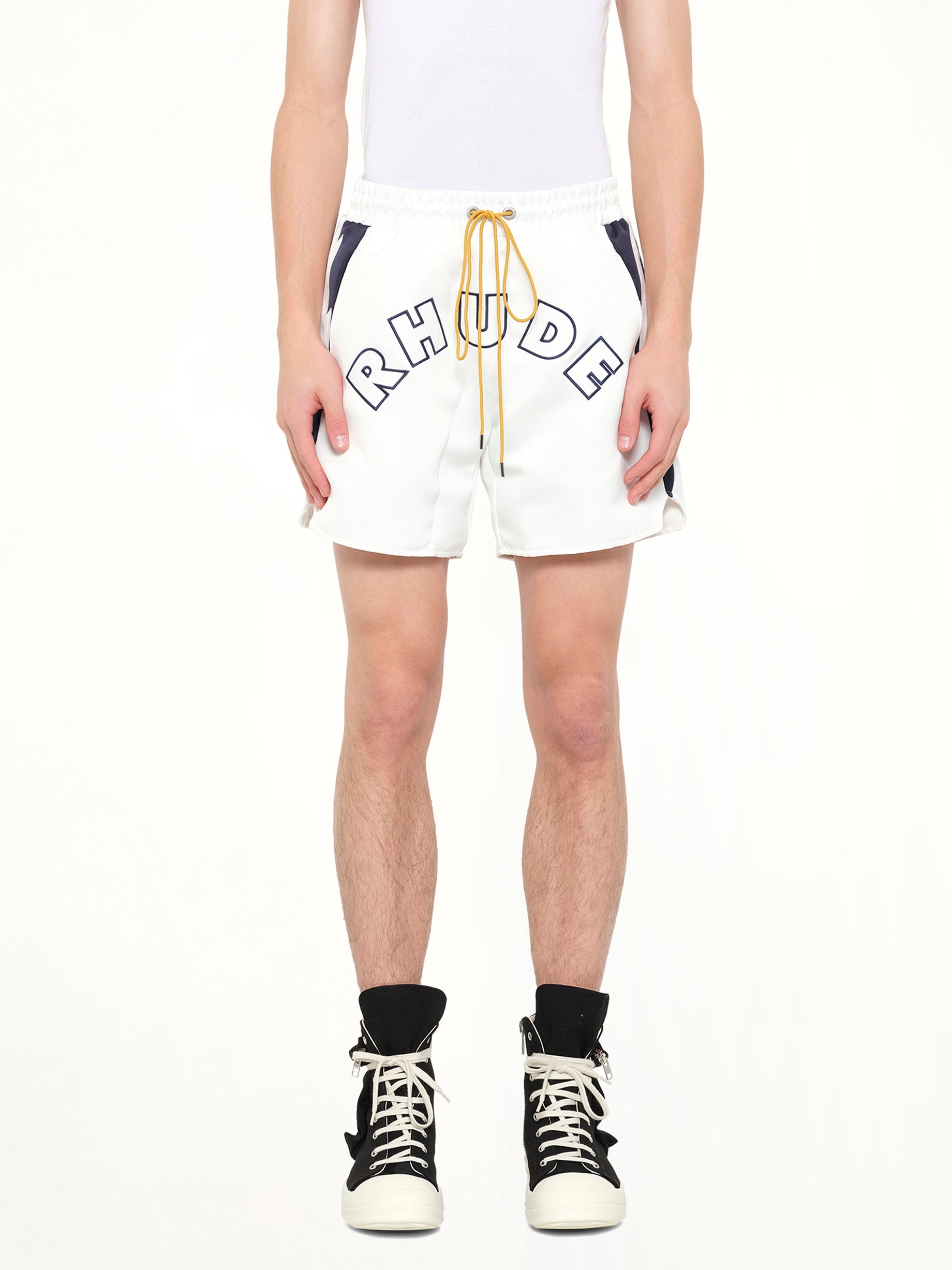 Image of a model wearing Shorts. Product name - Logo Lightning Shorts in White colour by brand - RHUDE
