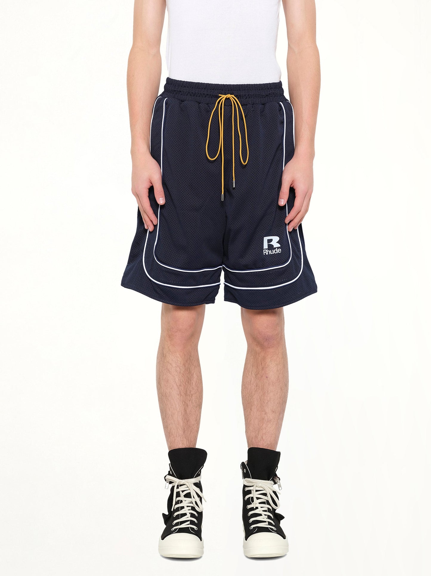 Image of a model wearing Shorts. Product name - Rhude Mesh Piping Baggy Track Short in Navy colour by brand - RHUDE