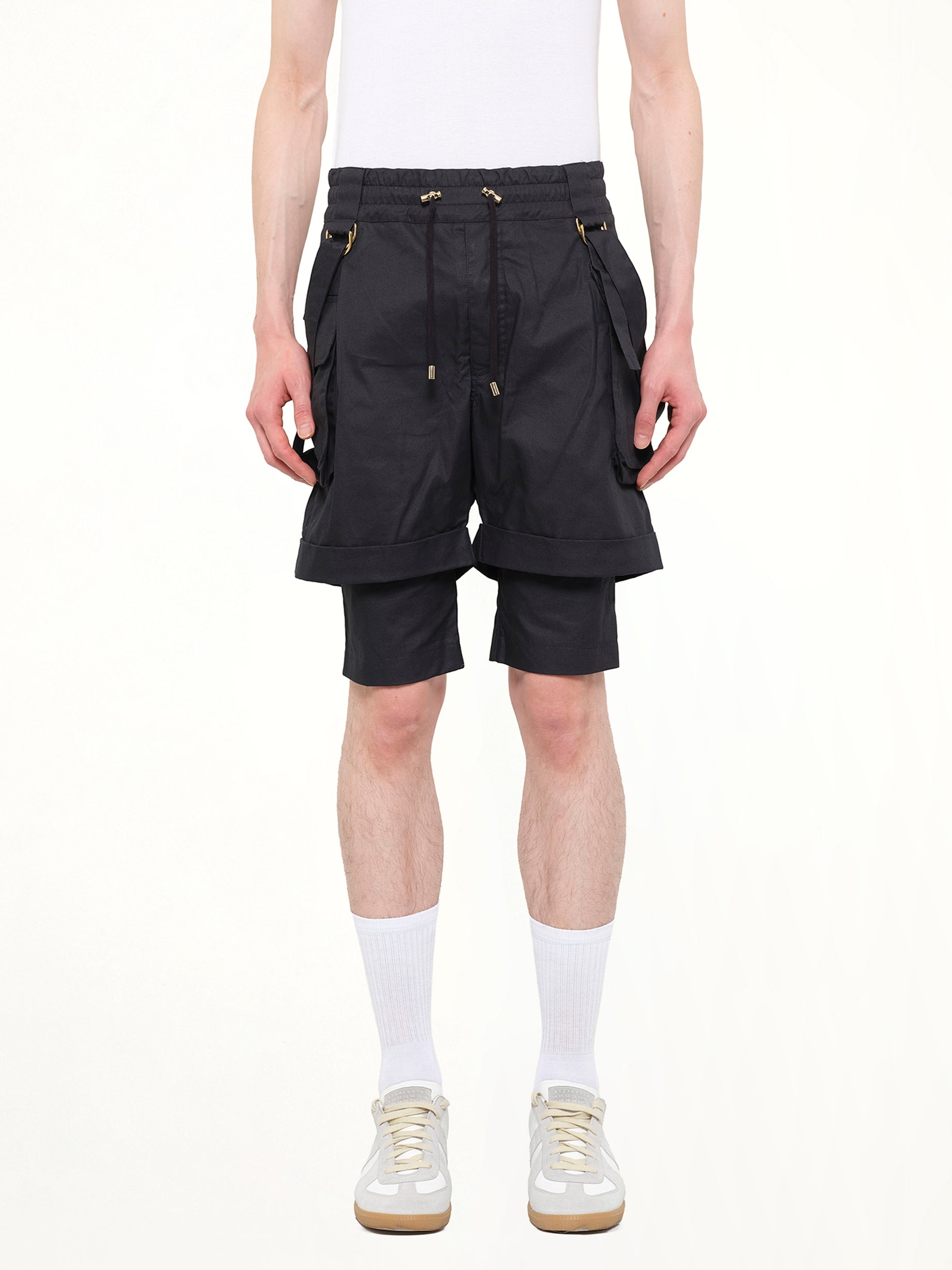 Image of a model wearing Shorts. Product name - Shorts in 176 colour by brand - BALMAIN