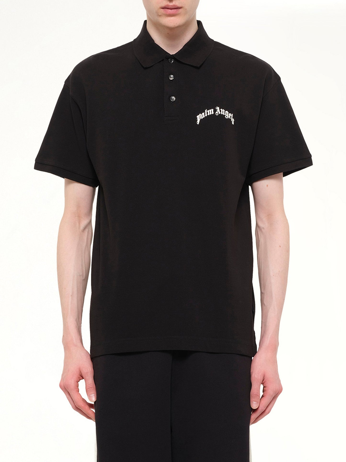 Image of a model wearing Tops. Product name - Back Curved Logo Polo S/S in Black colour by brand - PALM ANGELS