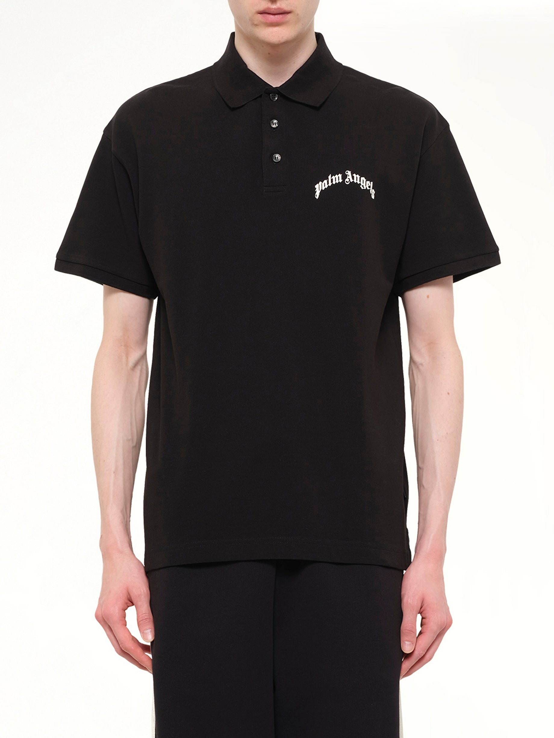 Image of a model wearing Tops. Product name - Back Curved Logo Polo S/S in Black colour by brand - PALM ANGELS