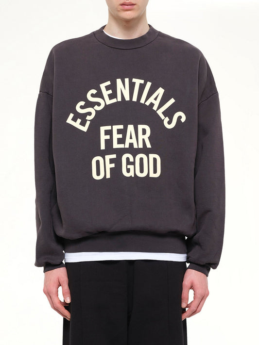 Image of a model wearing Outerwear. Product name - Campus 90's Crewneck Sweatshirt in Black colour by brand - FEAR OF GOD ESSENTIALS