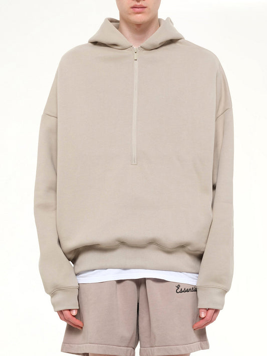Image of a model wearing Outerwear. Product name - Property Lounge Half Zip Hoodie in Grey colour by brand - FEAR OF GOD ESSENTIALS