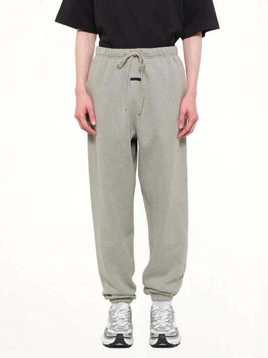 Image of a model wearing Pants. Product name - Signature Classic Sweatpant in Grey colour by brand - FEAR OF GOD ESSENTIALS