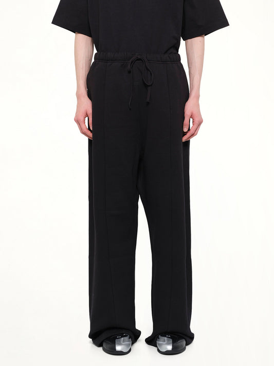 Image of a model wearing Pants. Product name - Signature Lounge Sweatpant in Black colour by brand - FEAR OF GOD ESSENTIALS