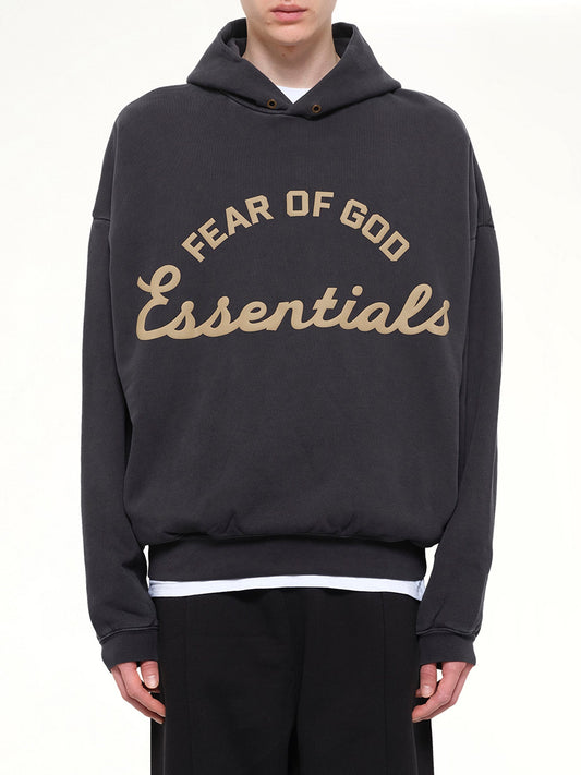 Image of a model wearing Outerwear. Product name - Training 90's Hoodie in Black colour by brand - FEAR OF GOD ESSENTIALS