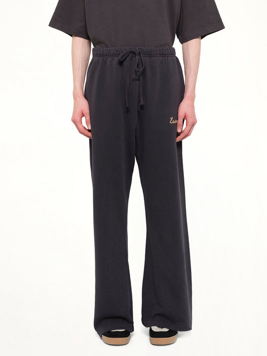 Image of a model wearing Pants. Product name - Training Classic Fit Flare Sweatpant in Black colour by brand - FEAR OF GOD ESSENTIALS