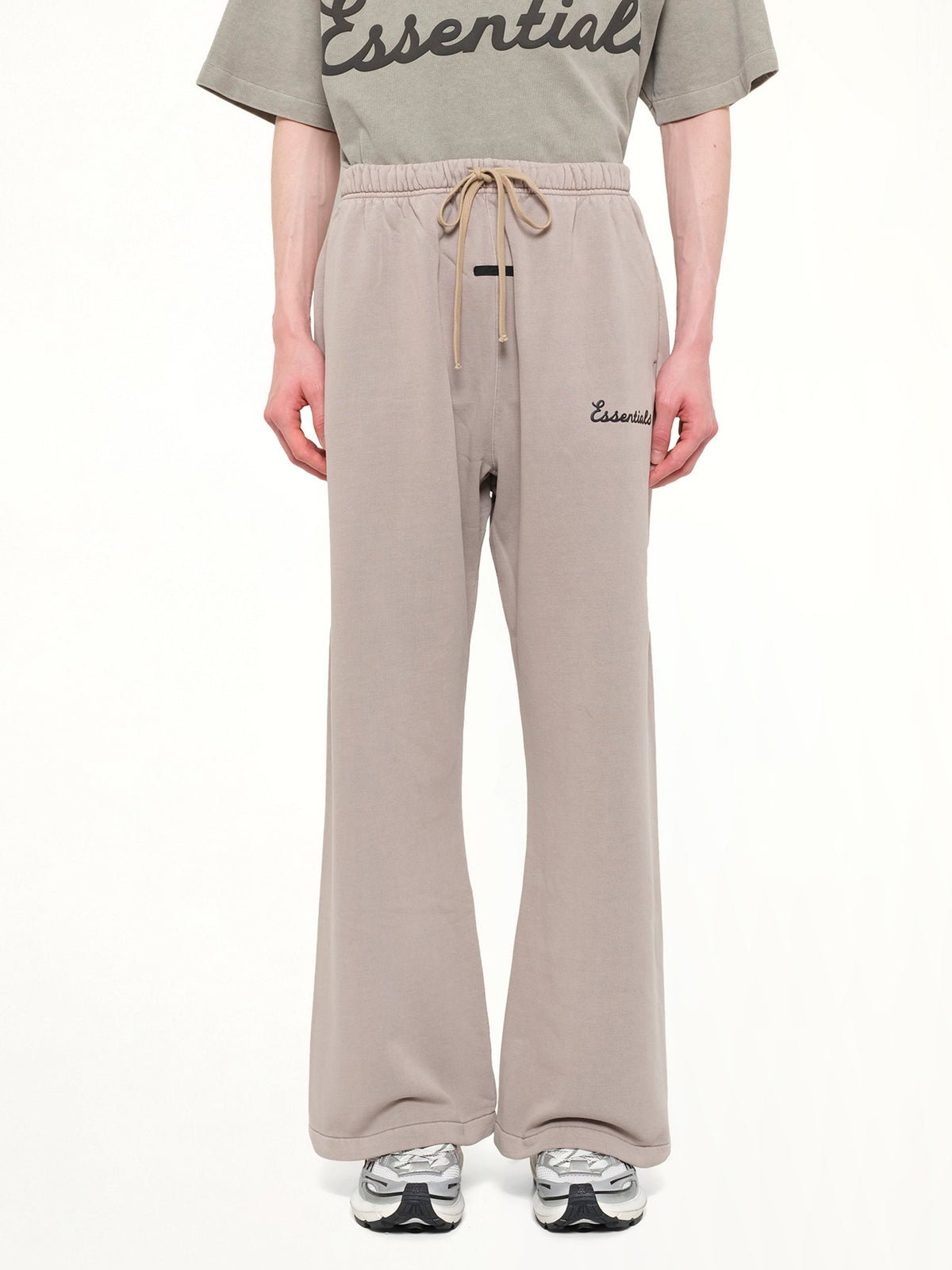 Image of a model wearing Pants. Product name - Training Classic Fit Flare Sweatpant in Grey colour by brand - FEAR OF GOD ESSENTIALS