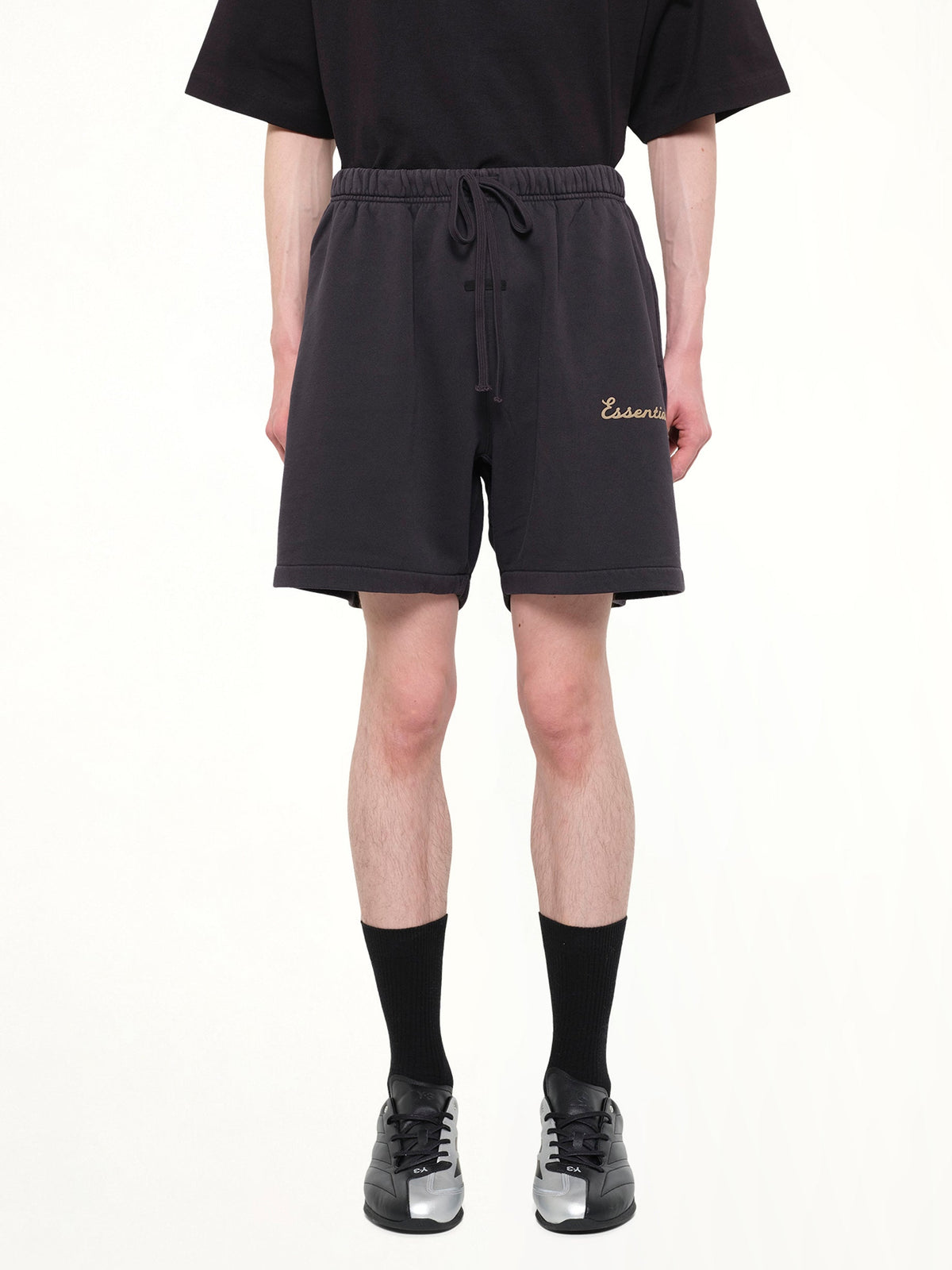 Image of a model wearing Shorts. Product name - Training Classic Fit Short in Black colour by brand - FEAR OF GOD ESSENTIALS