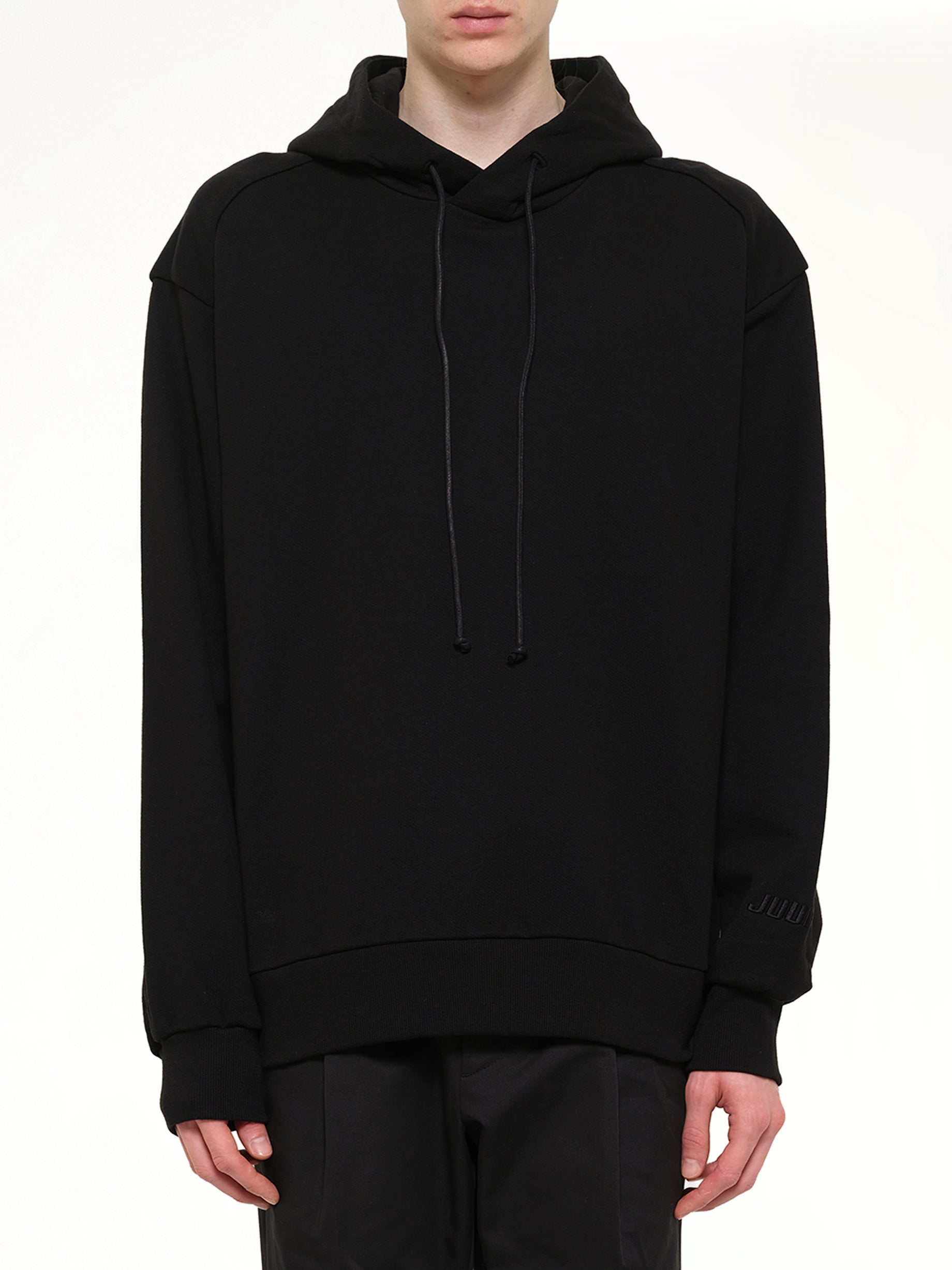 Image of a model wearing Outerwear. Product name - Juunj Hoodie Black in Black colour by brand - JUUNJ
