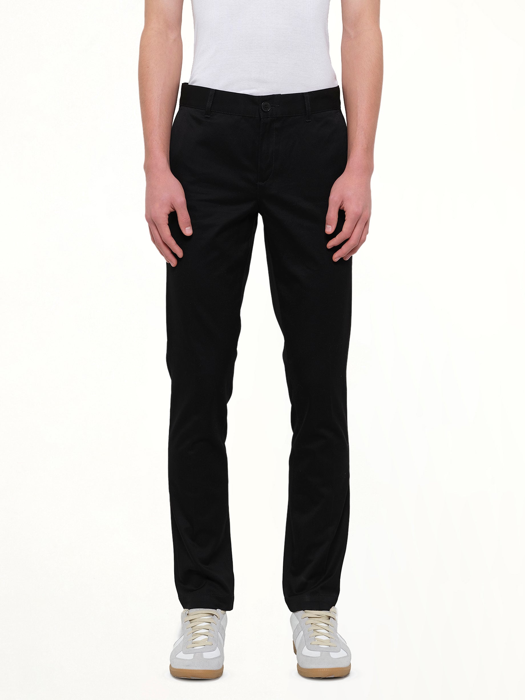 Image of a model wearing Pants. Product name - Chino Patch Pants in Black colour by brand - GIVENCHY