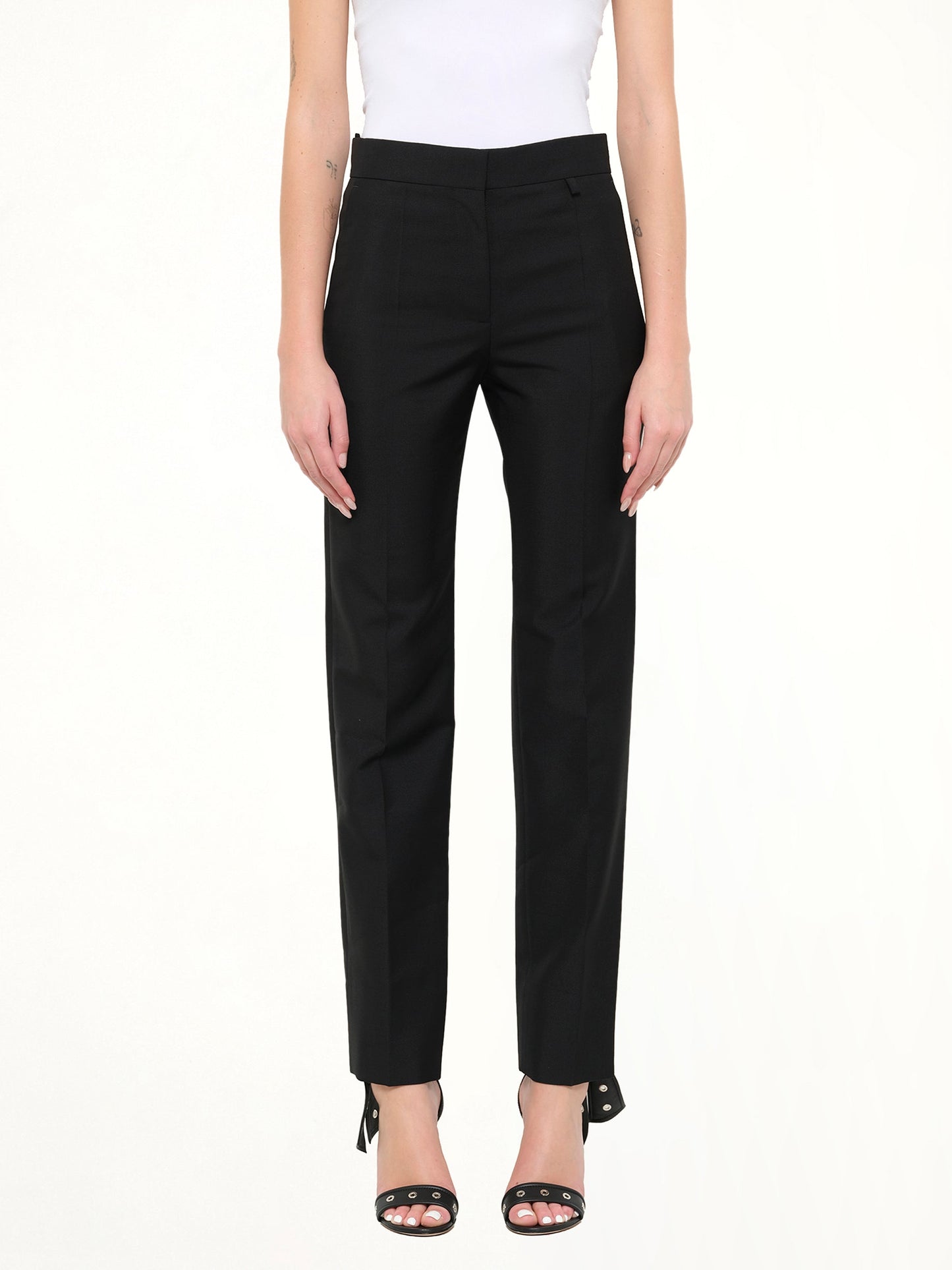 Image of a model wearing Pants. Product name - Classic Suit Pants in Black colour by brand - GIVENCHY