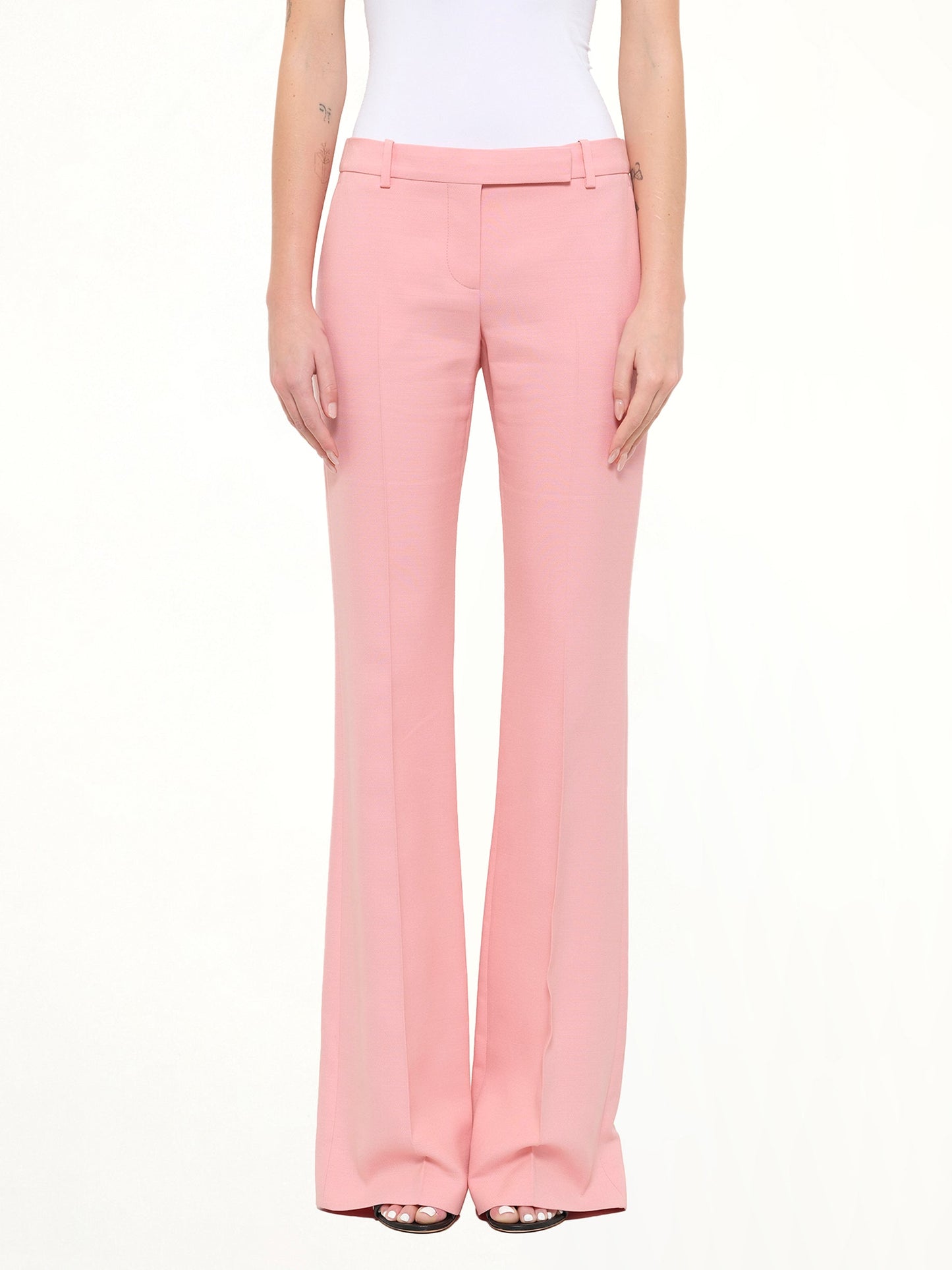 Image of a model wearing Pants. Product name - Narrow Bootcut Pants in Anemone colour by brand - ALEXANDER MCQUEEN