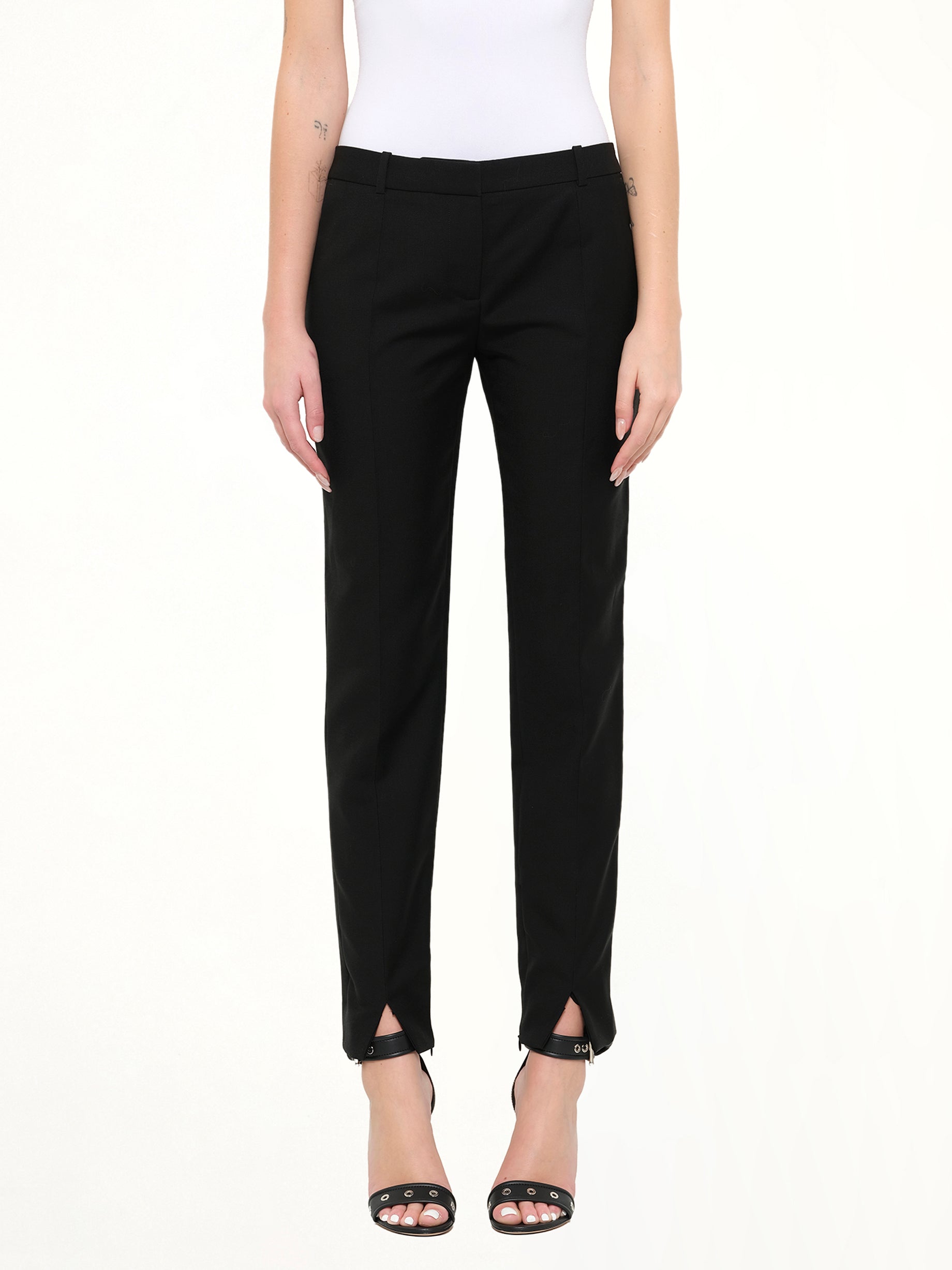 Image of a model wearing Pants. Product name - Pod Slim Fit Pants in Black colour by brand - GIVENCHY