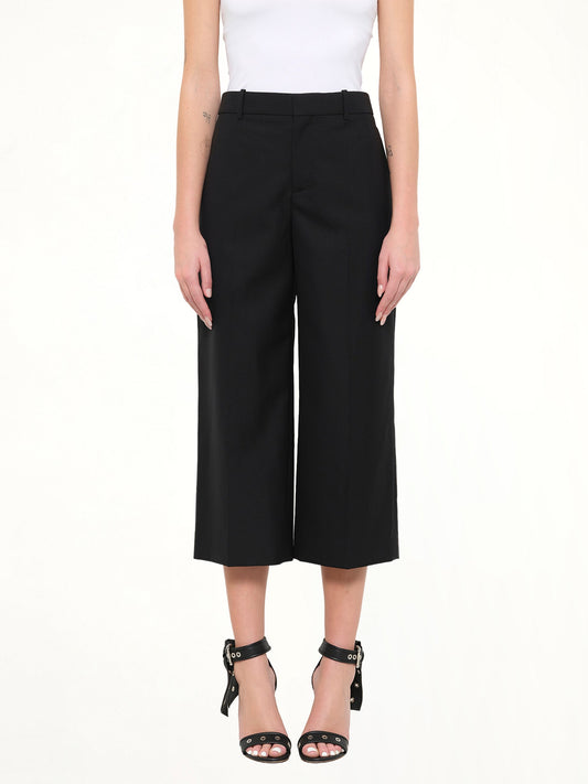 Image of a model wearing Pants. Product name - Short Wool Pants in Black colour by brand - GIVENCHY