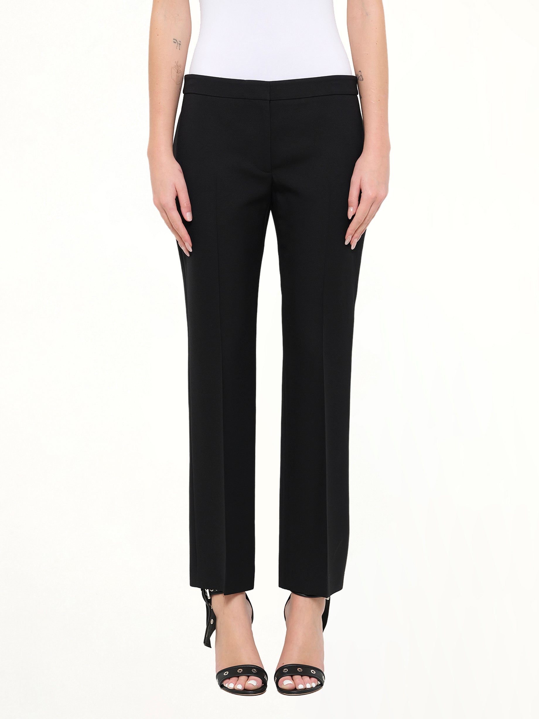 Image of a model wearing Pants. Product name - Wool Silk Pants in Black colour by brand - ALEXANDER MCQUEEN