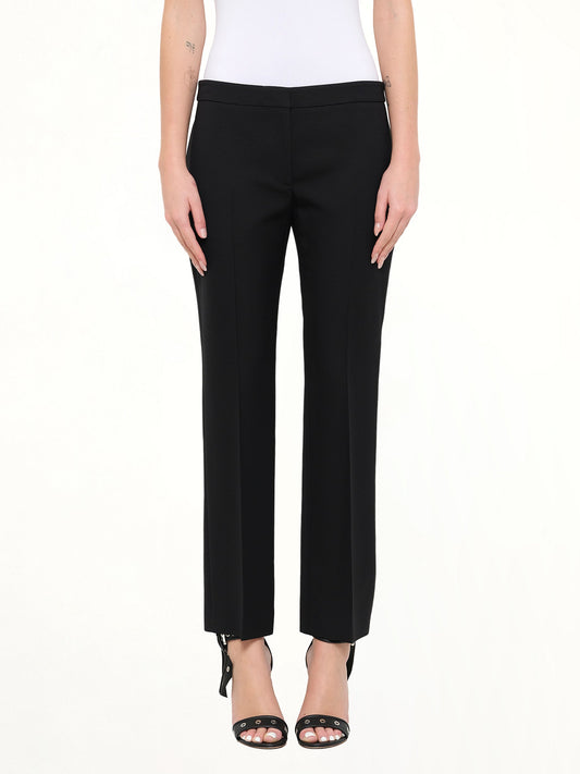 Image of a model wearing Pants. Product name - Wool Silk Pants in Black colour by brand - ALEXANDER MCQUEEN