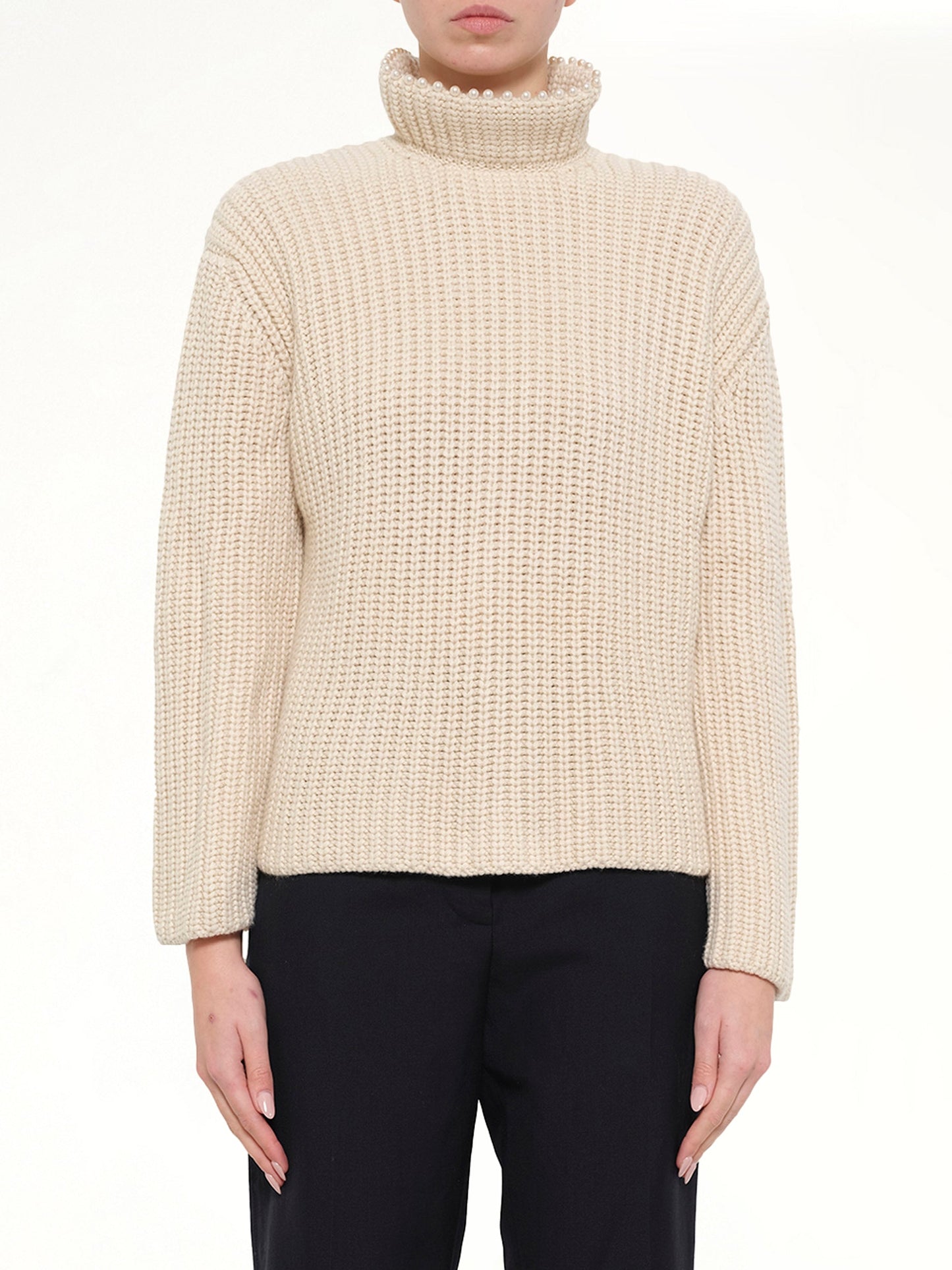 Image of a model wearing Outerwear. Product name - Crop Pearls Sweater in Beige colour by brand - LOEWE