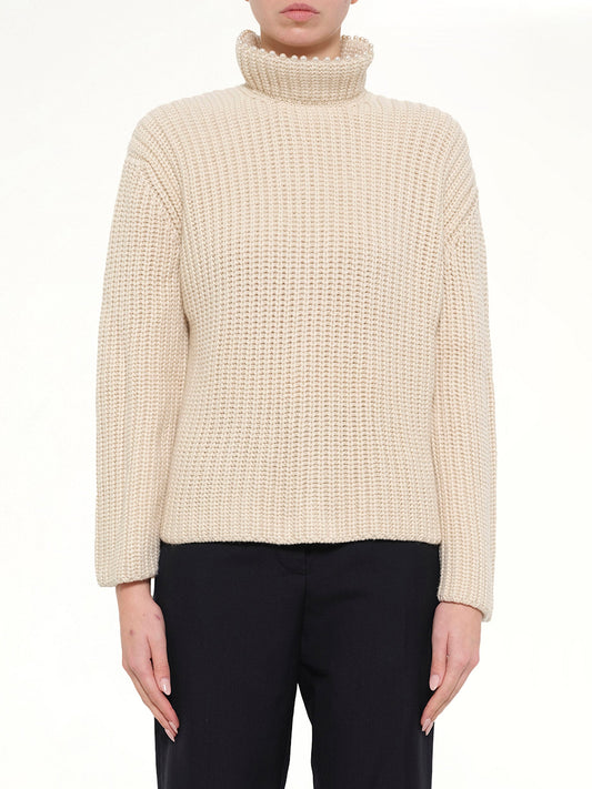 Image of a model wearing Outerwear. Product name - Crop Pearls Sweater in Beige colour by brand - LOEWE