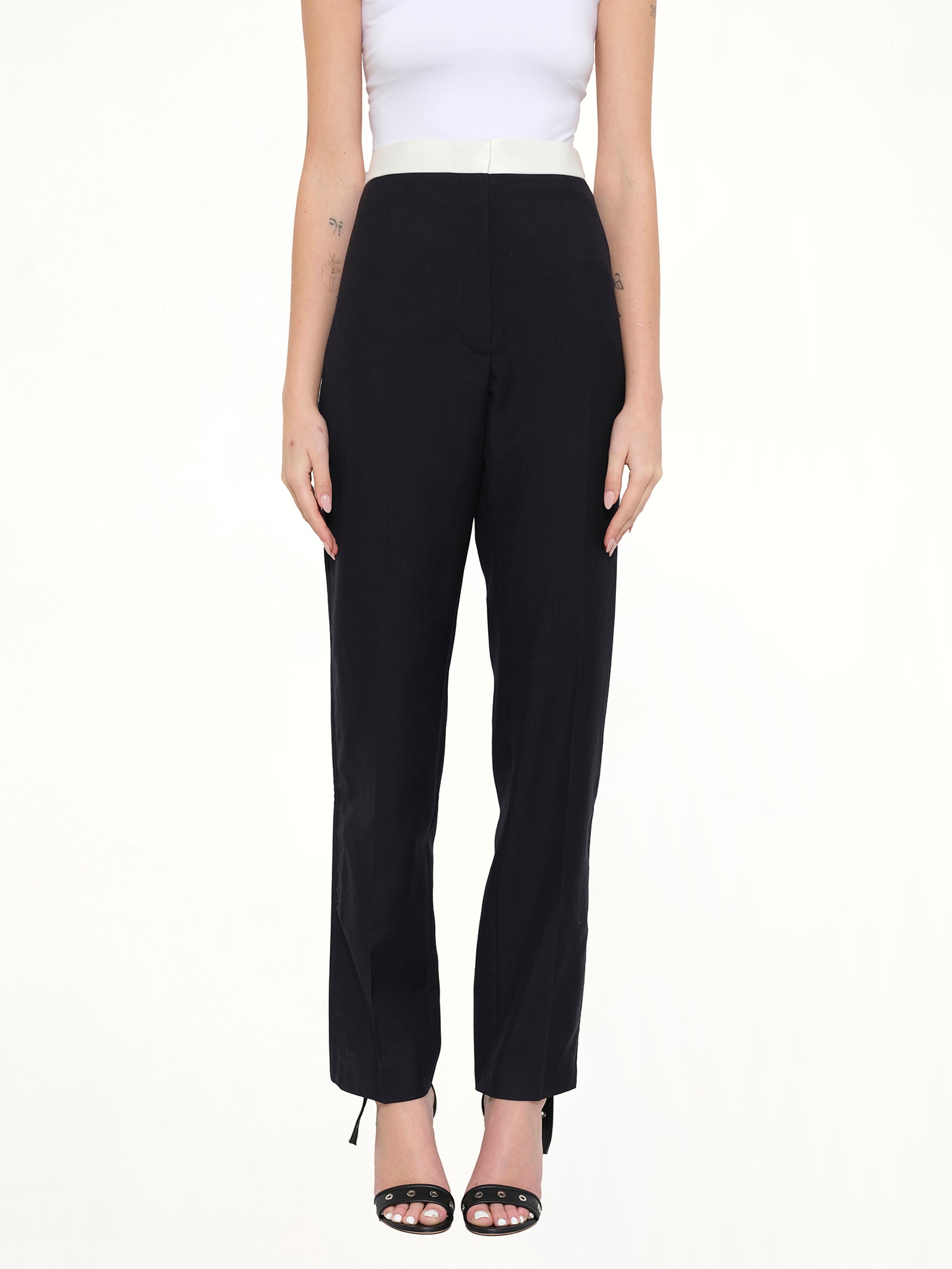 Image of a model wearing Pants. Product name - Tuxedo Trousers in Navy colour by brand - LOEWE